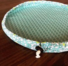 a close up of a frisbee on a wooden floor with a cloth cover