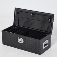 an open black box with two compartments on the inside and one in the middle, sitting on a white surface