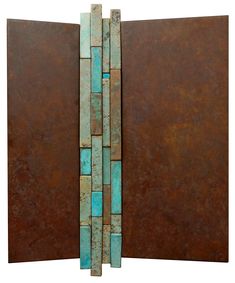 a metal wall sculpture with blue and brown tiles