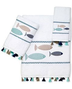 two white towels with fish on them