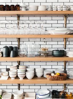 the shelves are full of dishes and glasses for sale on facebook, with one person looking at them