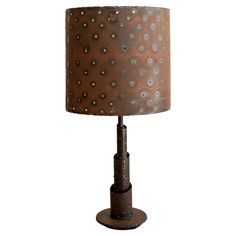 a metal lamp with a brown shade on it