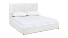 a white bed with two pillows on the headboard and one pillow on the foot board