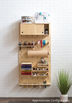 a white brick wall with a wooden shelf holding various items