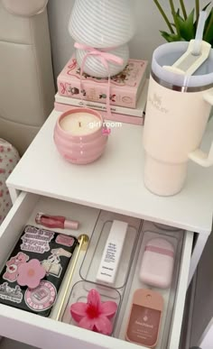 a white table topped with lots of items and a cup on top of it's shelf