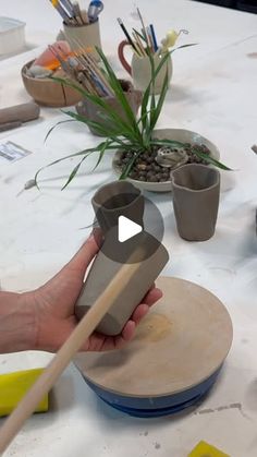 a person is making pottery on a table