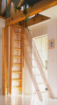 an empty living room with stairs leading up to the second floor