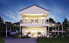 a two story house with white siding and balconies on the second floor at night