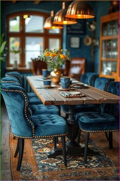 a dining room with blue chairs and a wooden table