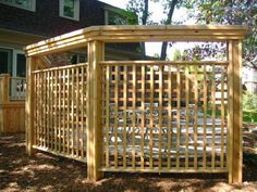 a wooden pergola in front of a house with trees and grass around it