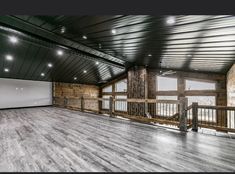 an empty room with wooden floors and white walls