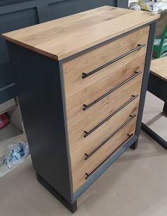 a wooden dresser sitting on top of a hard wood floor