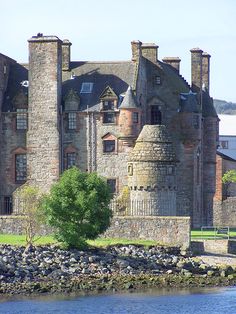 an old castle sitting next to a body of water