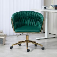 a green office chair sitting in front of a white desk