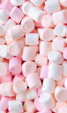 pink and white marshmallows are scattered together