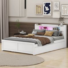 a white bed sitting in a bedroom on top of a hard wood floor