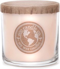 a candle that is inside of a glass jar with a label on the front and bottom