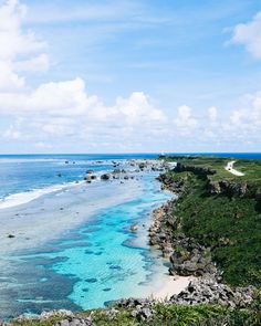 the ocean is blue and clear with white sand