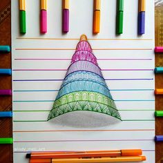 a drawing of a christmas hat with colored crayons around it on a sheet of paper