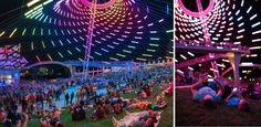 people are sitting and standing in the grass at an outdoor event with colorful lights on them