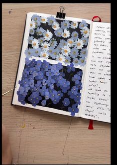 an open book with blue and white flowers on it