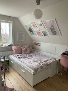 a bed sitting under a window in a bedroom