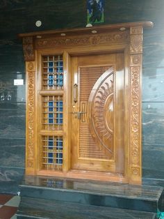 an ornate wooden door with glass panels on the front and side doors to both sides