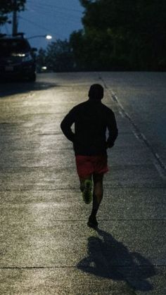 a man running down the street at night