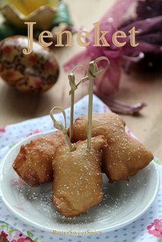 some food is sitting on a plate with toothpicks sticking out of the top