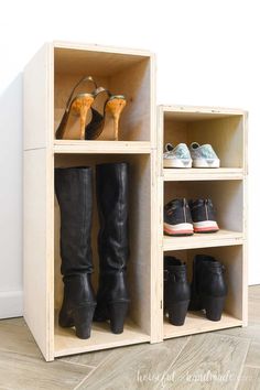 two pairs of boots are sitting in a wooden shoe rack