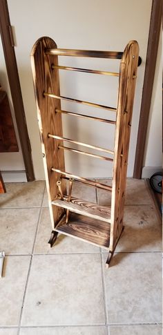 a wooden rack sitting on top of a tiled floor