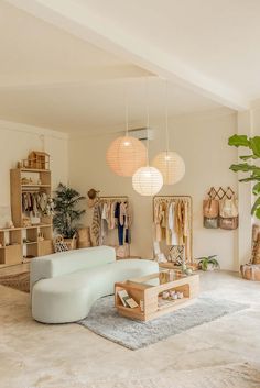 a living room filled with furniture and hanging lights