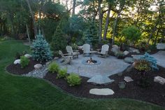 a fire pit surrounded by chairs and trees