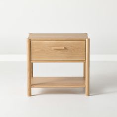 a small wooden table with one drawer open