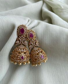 TEMPLE JHUMKA Kemp Ruby Stones Jhumka Earrings/Light weight /Antique Gold Finish/Indian Jewelry/desi jewelry / indian jhumkas Size : 3 inches approx  light weight  Elevate your style with these exquisite Temple Jhumka Earrings adorned with vibrant Kemp Ruby Stones and finished in antique gold. These Indian-inspired jhumkas are designed for both elegance and comfort, measuring approximately 3 inches in length and crafted to be delightfully lightweight. Embrace the timeless charm of desi jewelry with these stunning Indian jhumkas. Desi Jewelry, Jhumka Designs, Perhiasan India, Pretty Jewelry Necklaces, American Diamond Necklaces, Fancy Jewellery Designs, Jewelry Set Design, Multicolor Earrings, Indian Jewellery Design Earrings