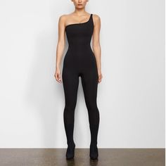 Both A Statement And An Essential. The One Shoulder Onesie Gives You All-Day Support And The Snatched Waist You've Been Searching For. This Pull-On Style Is Lined With Power Mesh For Added Support And Easy Wearing. Sold Out Online!! Catsuit Outfit, Mock Neck Bodysuit, Black Off Shoulder, Long Sleeve Onesie, Styling Tips, Black Sleeveless, Black Bodysuit, Catsuit, Personal Stylist