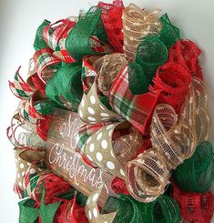 a christmas wreath made out of burlocks and mesh