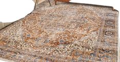 an area rug with a chair and table in front of it on a white background