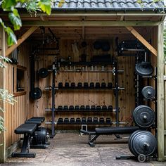 an outdoor gym with several different types of exercise equipment in front of the wall and on the floor