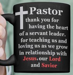 a person holding a black coffee mug with the words jesus, our lord and savor