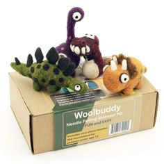 an assortment of stuffed animals sitting on top of a cardboard box