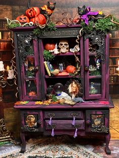 an old fashioned halloween cabinet with decorations on it