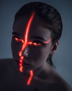 a woman with red light painted on her face