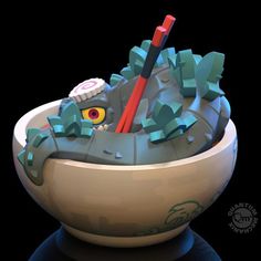 a bowl with a toothbrush in it that is shaped like a dragon's head