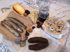 an assortment of food items displayed on a table with coins and other things to eat