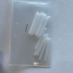 several white toothbrushes in a clear plastic package