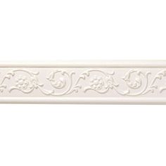 a white wallpaper border with scrolls and flowers