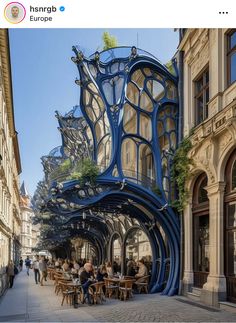 an artisticly designed building in europe with people sitting at tables and walking down the street