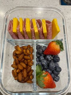 a plastic container filled with fruit and nuts