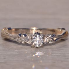 an antique diamond ring on a wooden surface